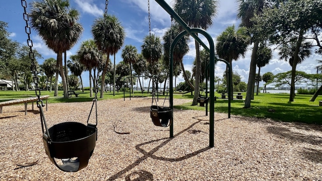 view of home's community featuring a lawn and a playground