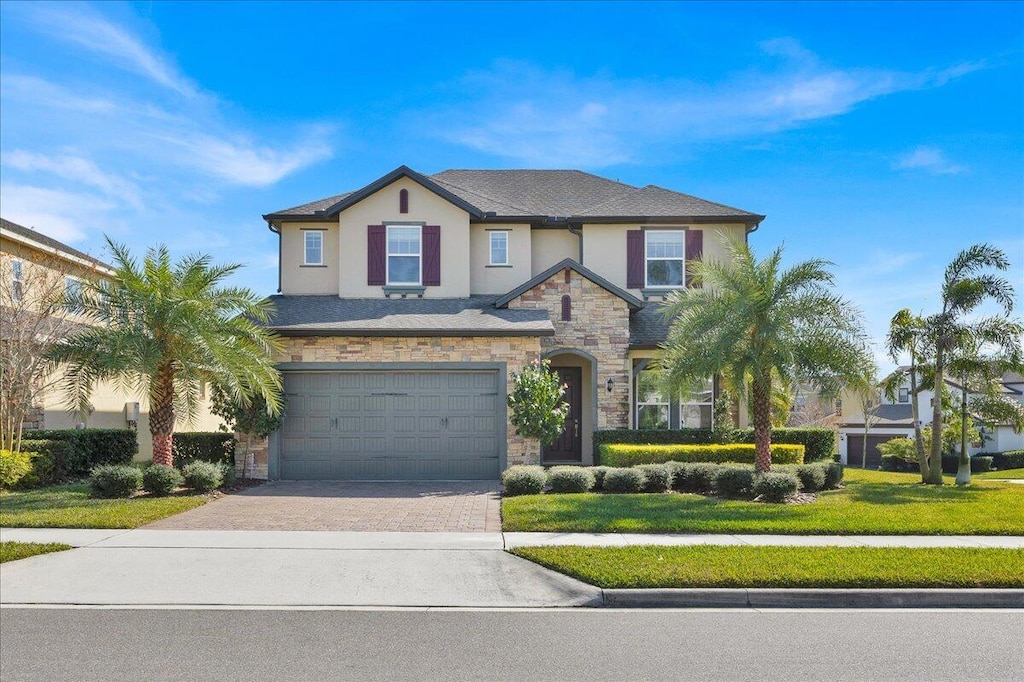 view of front of property with a garage and a front lawn