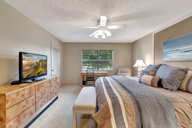 carpeted bedroom with a textured ceiling and ceiling fan