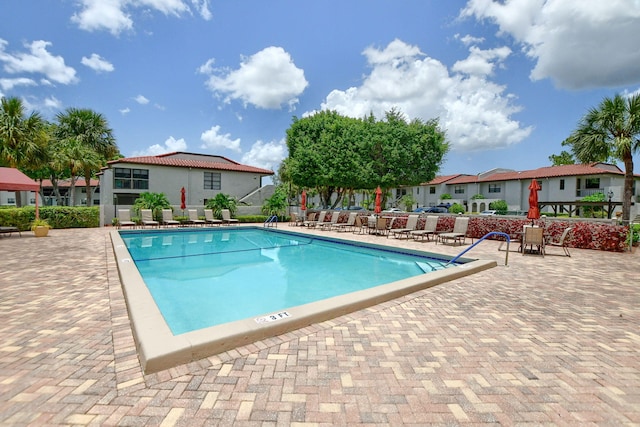 view of swimming pool featuring a patio area