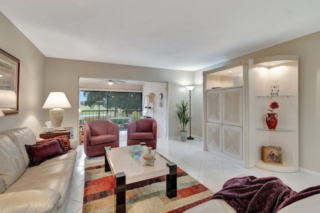 tiled living room with ceiling fan and a textured ceiling