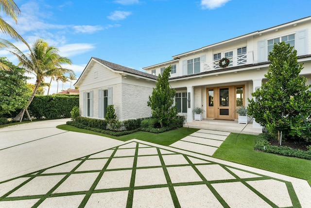 view of front of property with a balcony and a front yard