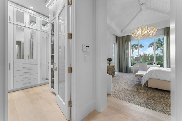 interior space featuring wooden ceiling, an inviting chandelier, hardwood / wood-style floors, and vaulted ceiling with beams