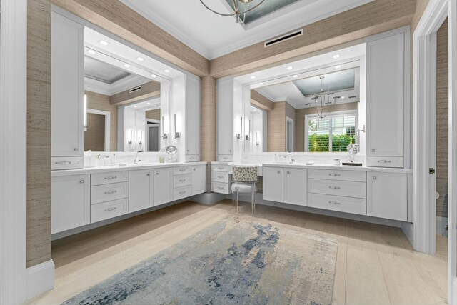 bathroom with ornamental molding, an inviting chandelier, plus walk in shower, and wood-type flooring