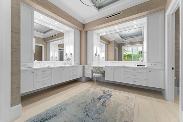 bathroom with ornamental molding, an inviting chandelier, plus walk in shower, and wood-type flooring