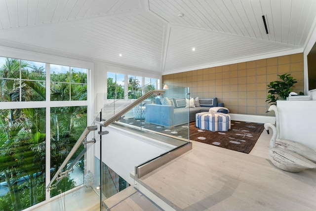 sunroom with lofted ceiling and wooden ceiling