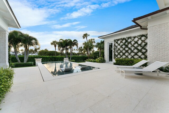 back of house with a yard and a patio