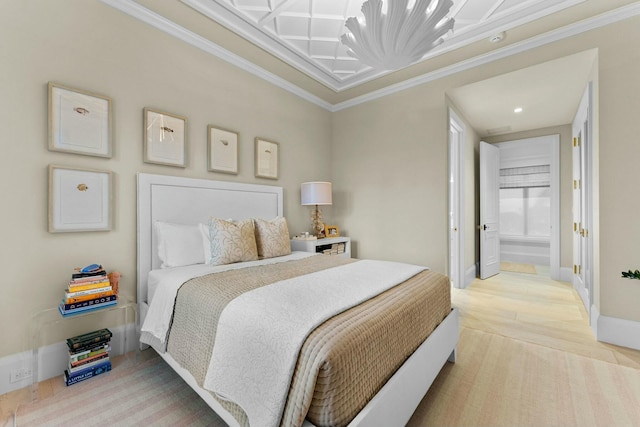 bedroom featuring crown molding, ensuite bath, and wood-type flooring