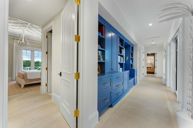 bedroom featuring crown molding, ensuite bath, and wood-type flooring