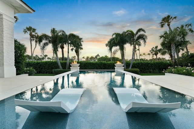 view of pool at dusk