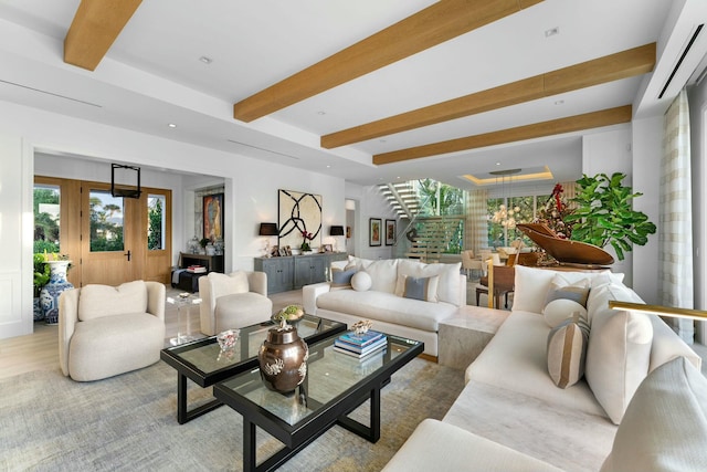 living room with beamed ceiling and light hardwood / wood-style flooring