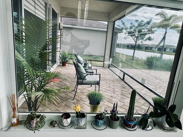 sunroom featuring a water view