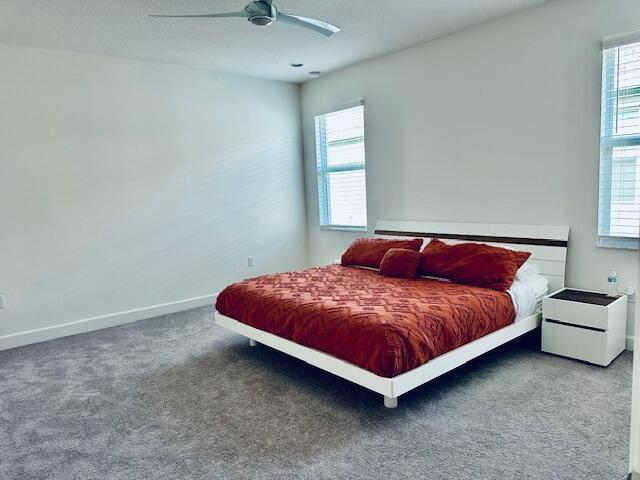 bedroom featuring ceiling fan and carpet flooring