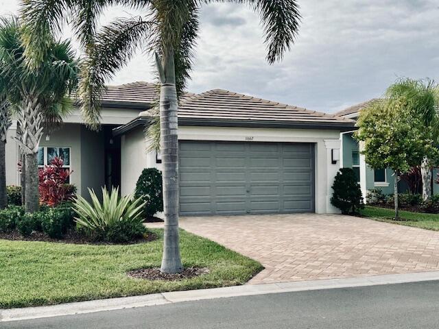 ranch-style home with a front lawn and a garage