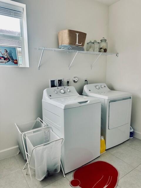 laundry area featuring light tile patterned floors and independent washer and dryer