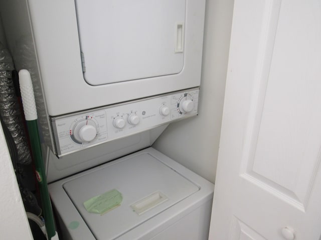 laundry room with stacked washer / drying machine