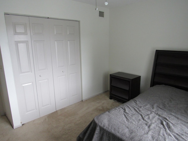 bedroom with a closet and light carpet