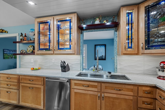 kitchen with light stone countertops, dark wood-type flooring, sink, backsplash, and stainless steel dishwasher