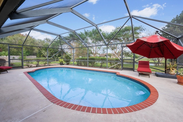 view of swimming pool with glass enclosure and a patio area