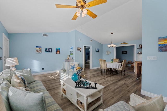 living room featuring vaulted ceiling, dark hardwood / wood-style flooring, and ceiling fan with notable chandelier