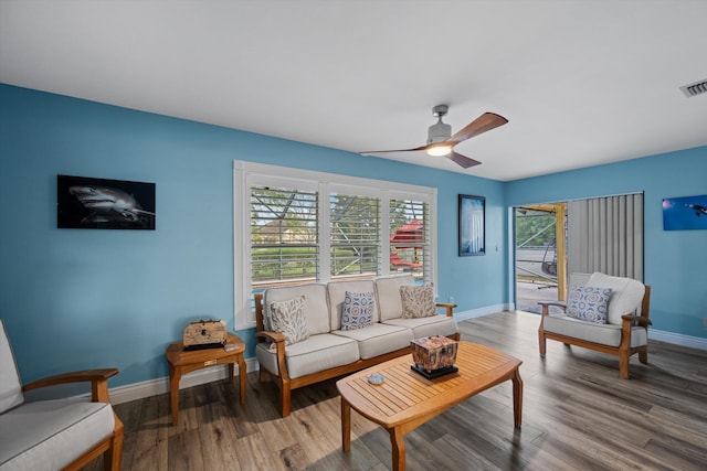 living room with ceiling fan and hardwood / wood-style flooring