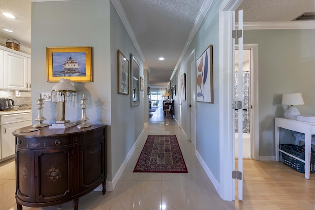 corridor featuring a textured ceiling and crown molding