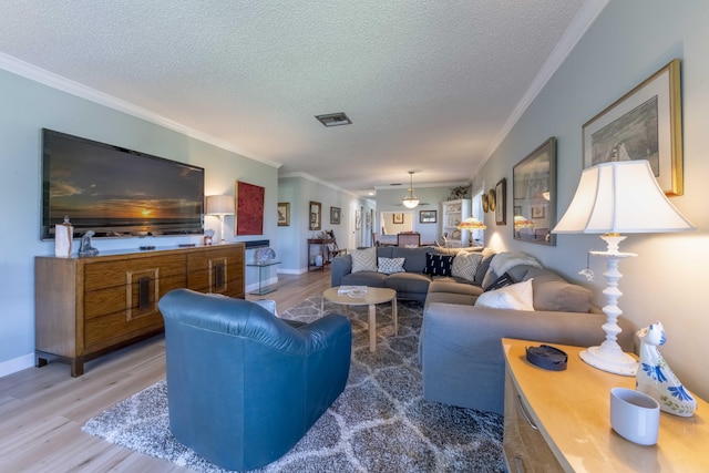 living room featuring a textured ceiling, crown molding, and hardwood / wood-style floors