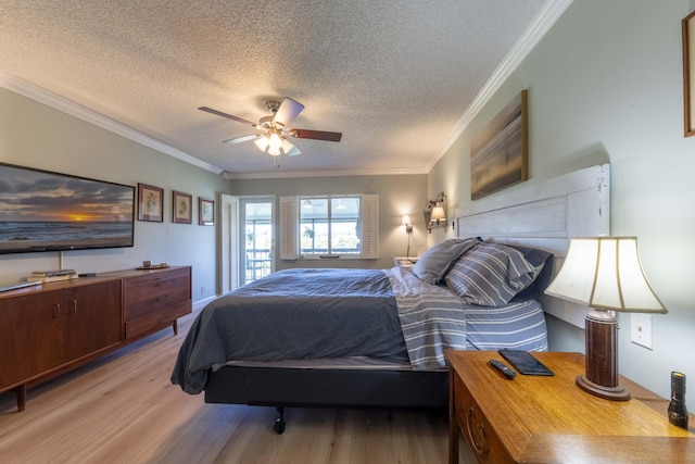 bedroom with ceiling fan, light wood-type flooring, ornamental molding, and a textured ceiling