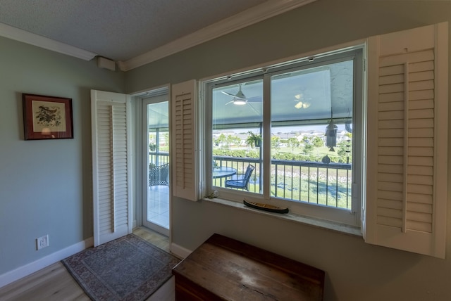 entryway with light hardwood / wood-style floors and crown molding