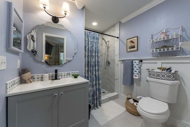 bathroom with toilet, crown molding, vanity, and curtained shower