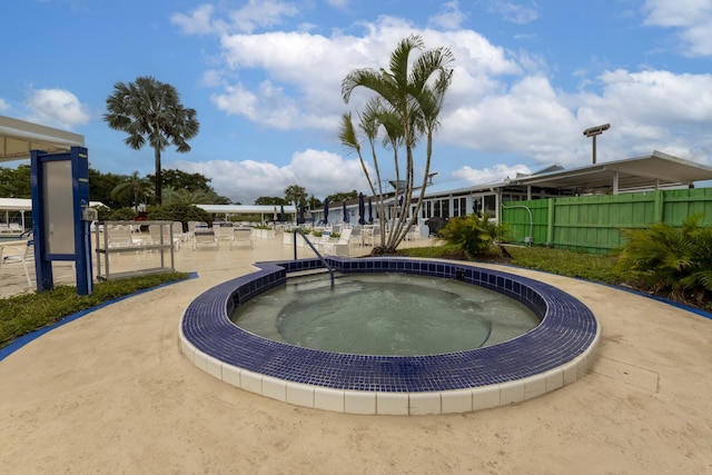 view of pool featuring a community hot tub and a patio