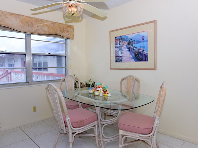 tiled dining room featuring ceiling fan