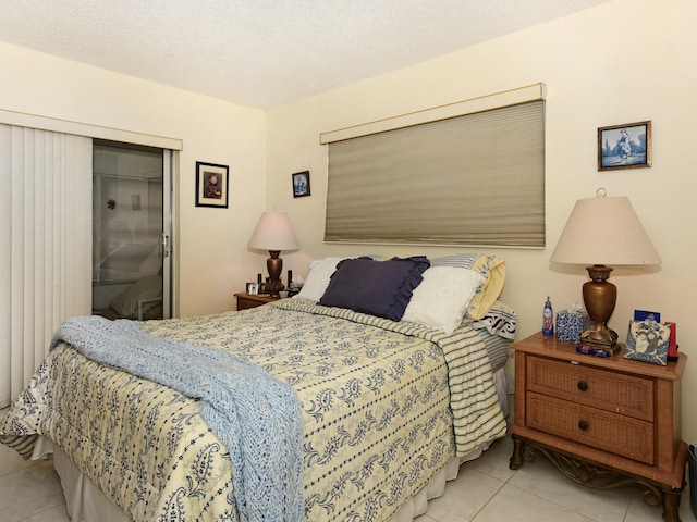 bedroom featuring a textured ceiling and light tile patterned floors