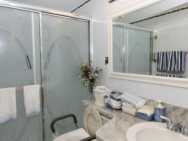 bathroom with a shower with door and vanity