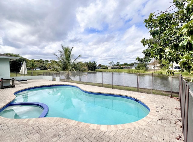 view of swimming pool featuring a patio, an in ground hot tub, and a water view