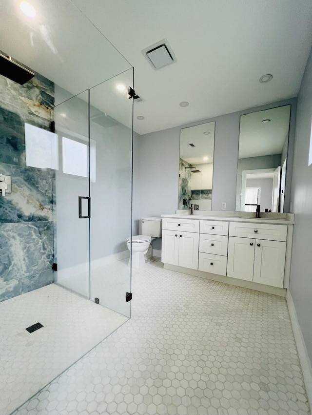 bathroom with vanity, a shower with shower door, and toilet