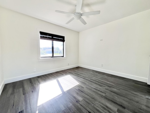 empty room featuring dark hardwood / wood-style flooring and ceiling fan