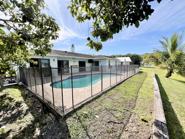 view of swimming pool with a lawn and a patio