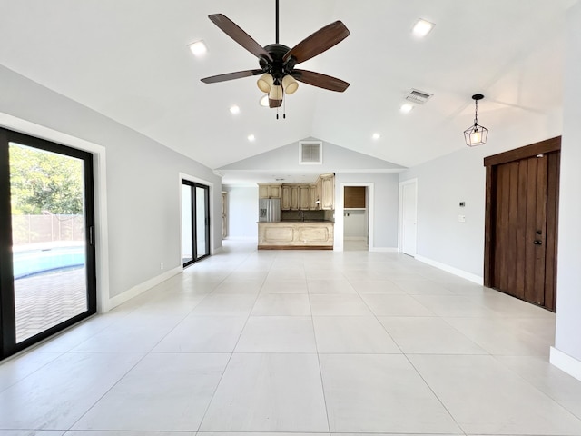 unfurnished living room featuring ceiling fan, vaulted ceiling, and light tile patterned floors