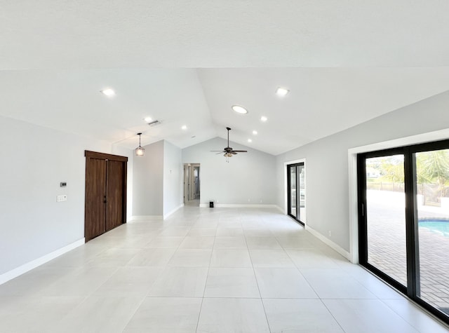 spare room with light tile patterned flooring, ceiling fan, and vaulted ceiling