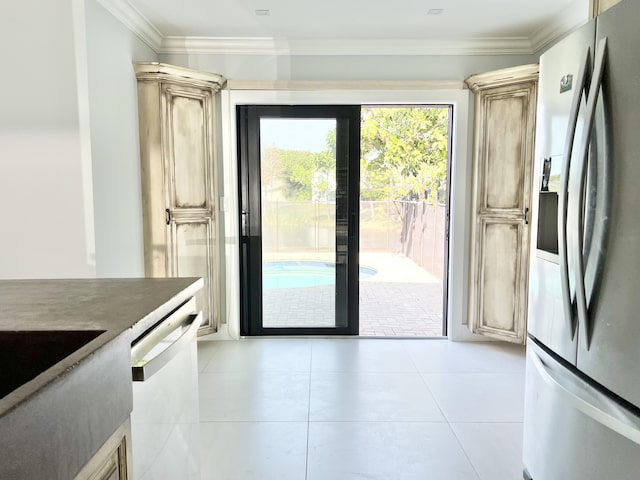 doorway to outside with crown molding, sink, and light tile patterned flooring