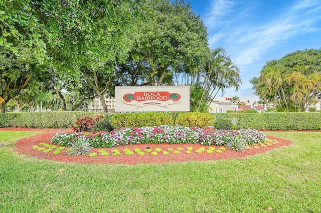 community / neighborhood sign with a yard