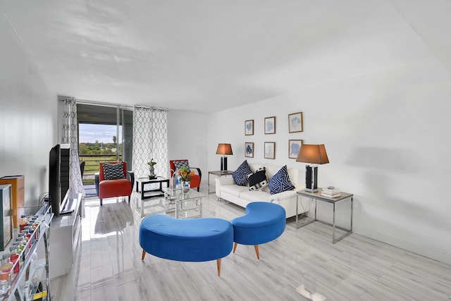 living room featuring light hardwood / wood-style floors and floor to ceiling windows