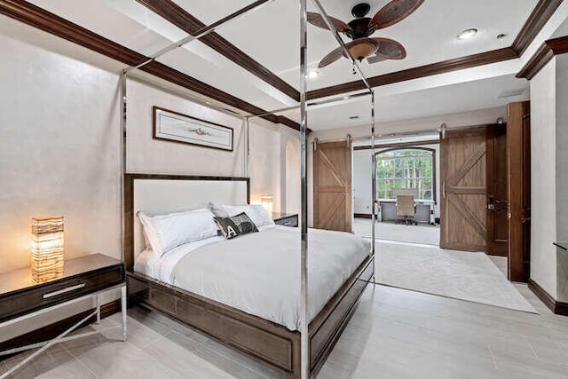 bedroom featuring a raised ceiling, ornamental molding, and a barn door