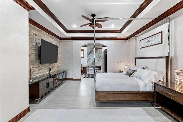 unfurnished bedroom with crown molding, a tray ceiling, and light hardwood / wood-style floors