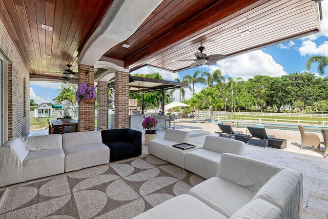 view of patio featuring an outdoor hangout area and ceiling fan