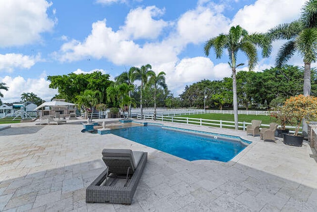 view of swimming pool featuring a patio area