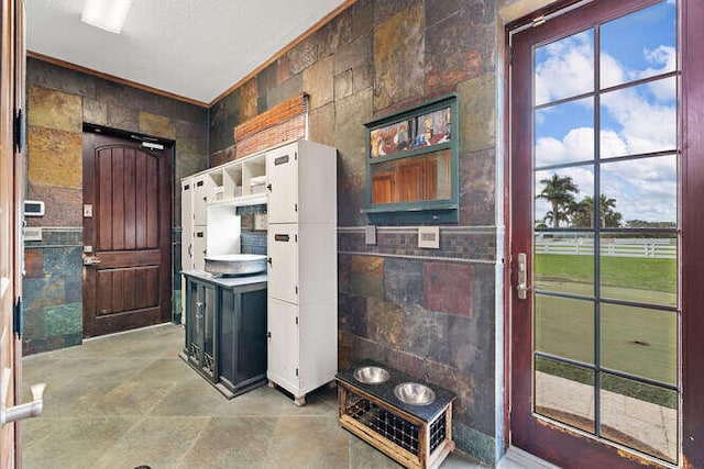 kitchen featuring tile walls and white cabinets