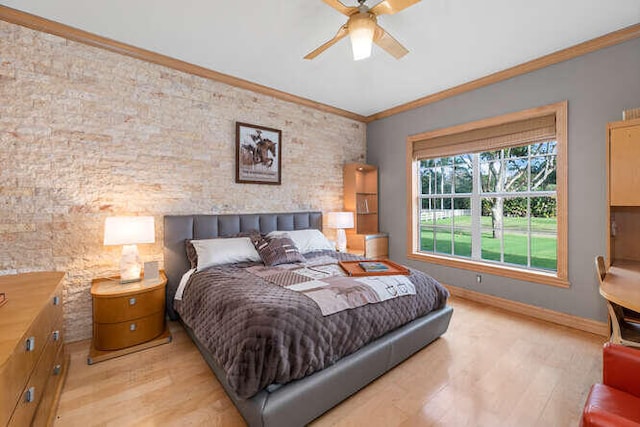 bedroom featuring ornamental molding, light hardwood / wood-style floors, and ceiling fan