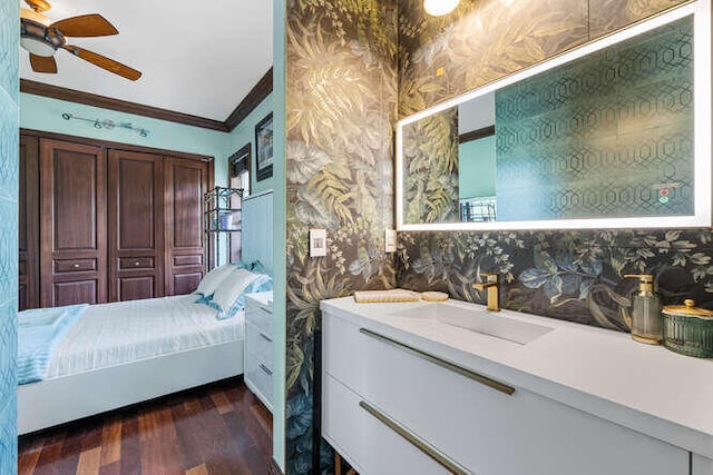 bathroom featuring crown molding, ceiling fan, vanity, and hardwood / wood-style flooring